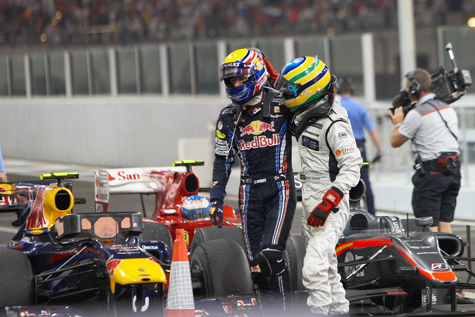 After the race in parc ferme after loosing the championship, Mark Webber gets a friendly tap on the helmet from Bruno Senna