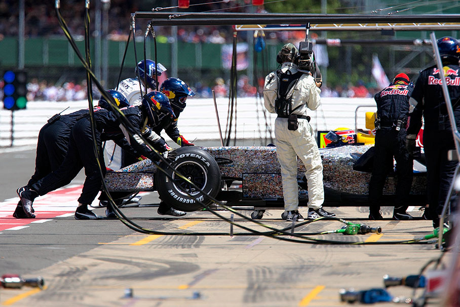 Mark Webber's Red Bull being pushed back to pits with hydraulic problems