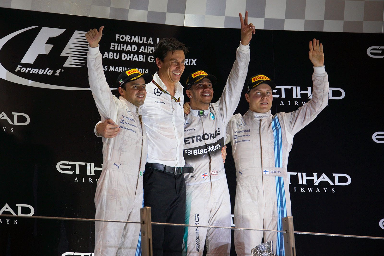Final Abu Dhabi Grand Prix podium shot: 2nd Felipe Massa, Williams, director of Mercedes-Benz Motorsport Toto Wolff, race winner and 2014 World Champion for Mercedes Lewis Hamilton and 3rd Valtteri Bottas, Williams