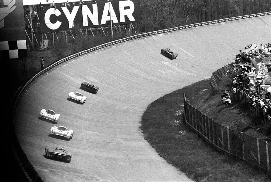 The endurance battle between three Porsches and two leading Ferraris continues at Monza's steep turn whilst a following Matra sticks at the back