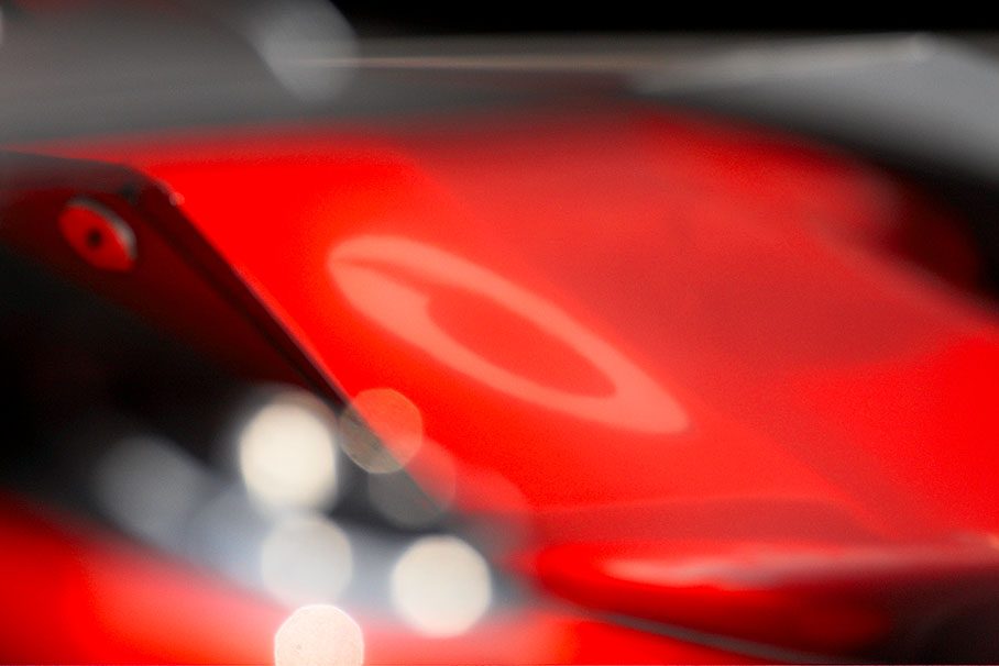 A reflection of a Vodafone logo on a McLaren wing