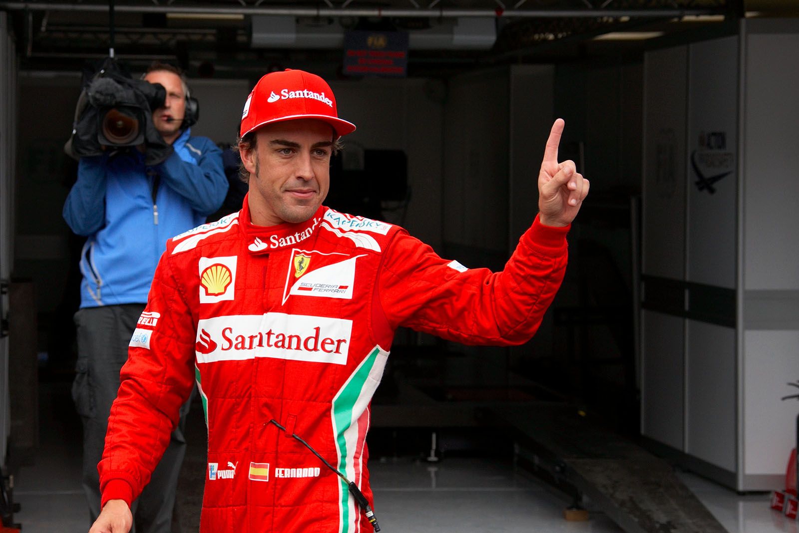 Polesetter Fernando Alonso of Ferrari celebrates his achievement after qualifying
