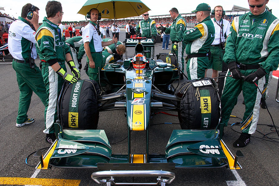 Jarno Trulli in his Lotus surrounded by mechanics before the British GP 2010