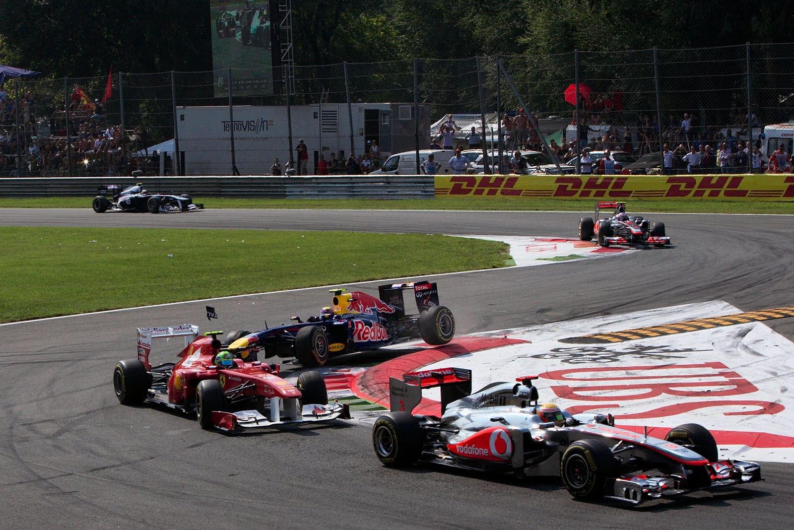 Mark Webber battles for fifth position and takes the curbs too optimistically, damaging his front wing at Massa's rear side