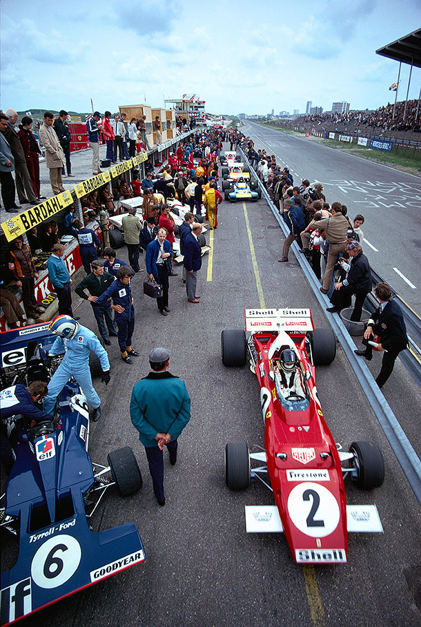 Jacky Ickx, Ferrari, on his way out of the pits, while French driver Francoise Cevert is stepping into the cockpit of his Tyrrell