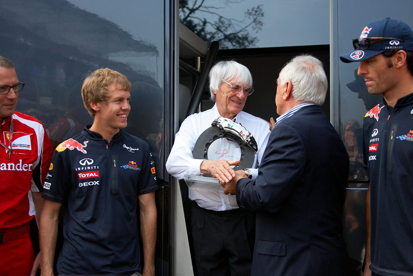 Bernie Ecclestone receives an honoury trophy from Brembo brakes chairman Alberto Bombassei
