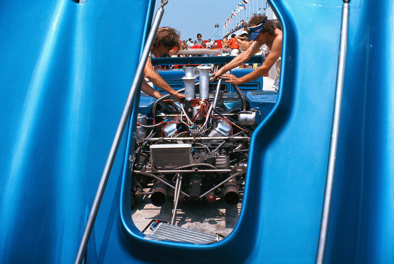 Spy view through the engine cover of FranÁois Cevert's (F) McLaren M8F Chevrolet at the busy mechanics