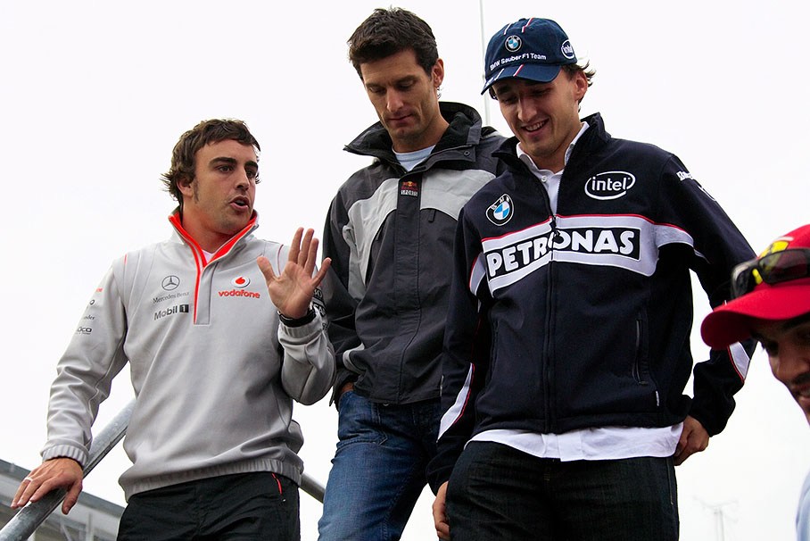 Fernando Alonso, Mark Webber and Robert Kubica walk the stairs down to paddock after drivers briefing