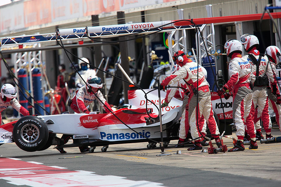 Ralf's Toyota is pushed backwards into pits