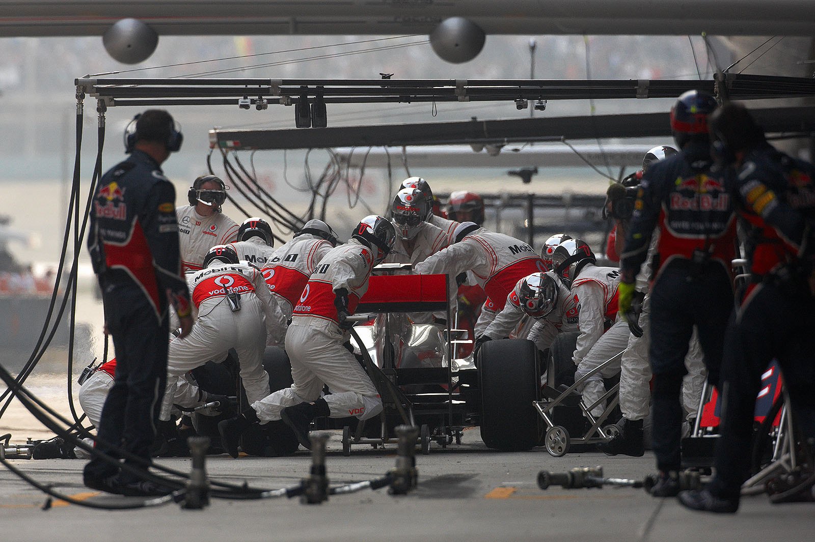 The McLaren pit crew process Lewis Hamilton