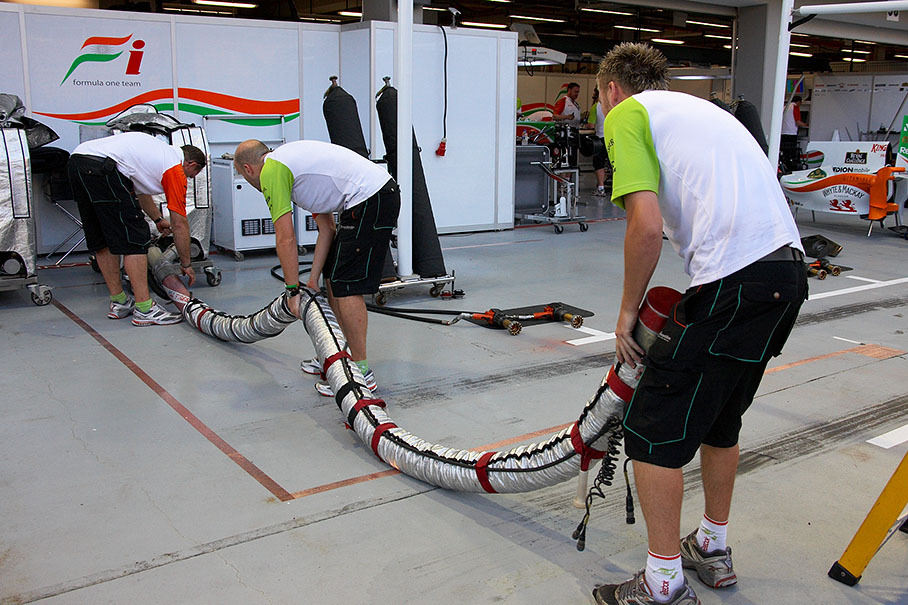Force India mechanics put the fuel hose down