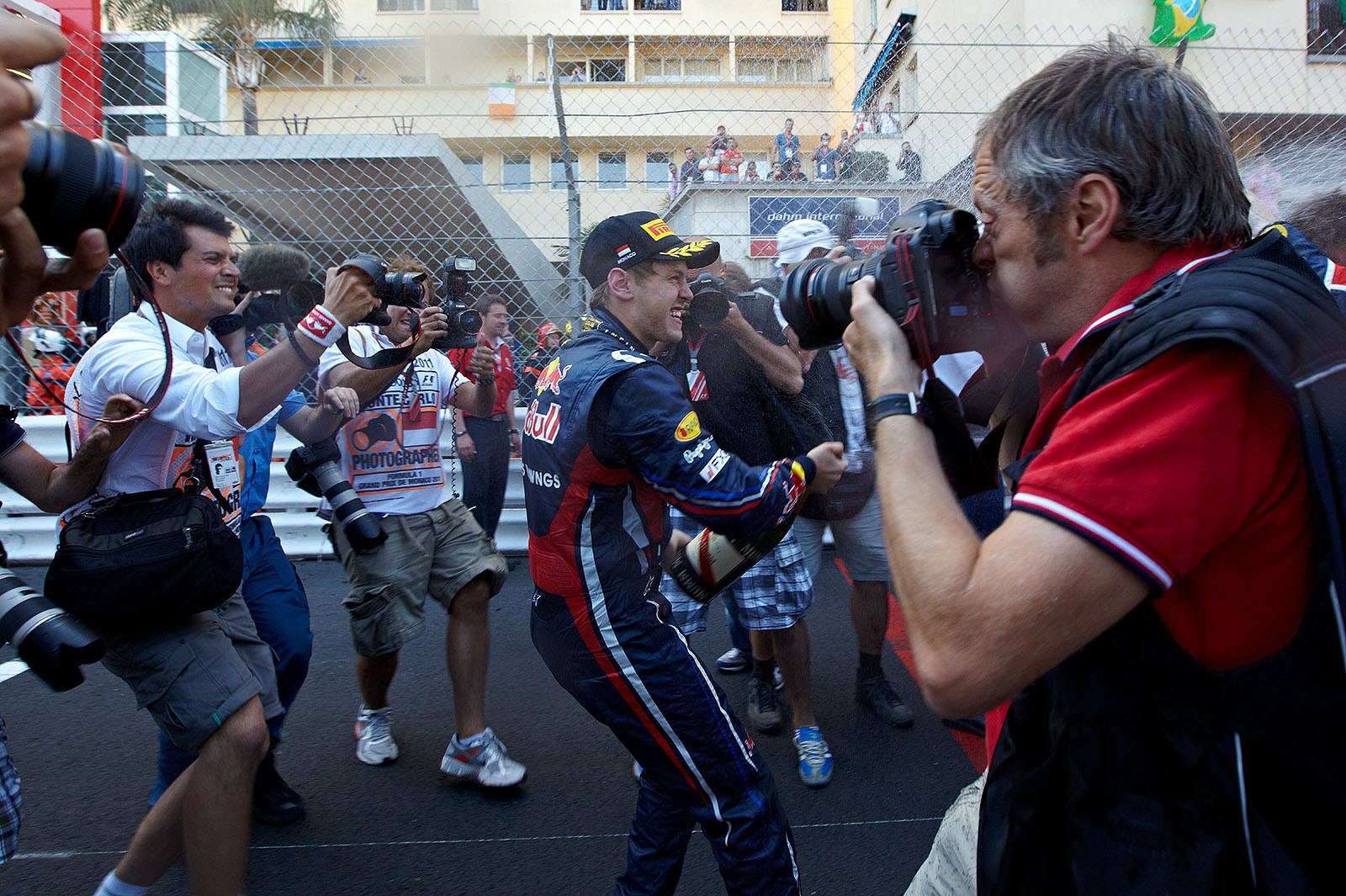 Race winner Sebastian Vettel celebrates between the photographers in front of the Monaco podium