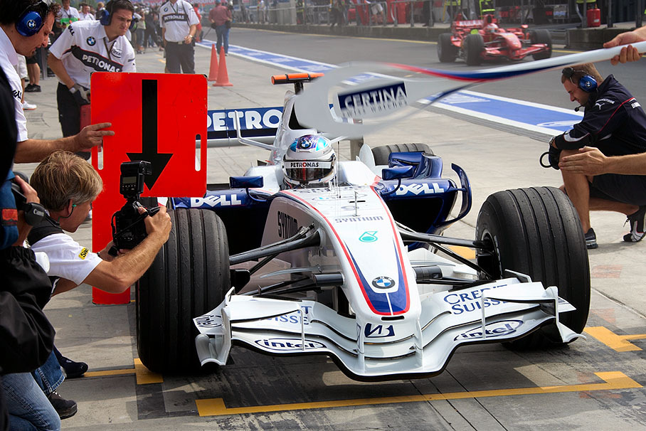 Swiss colleague Dani Reinhard pictures Quick Nick during a BMW Sauber pit stop practice
