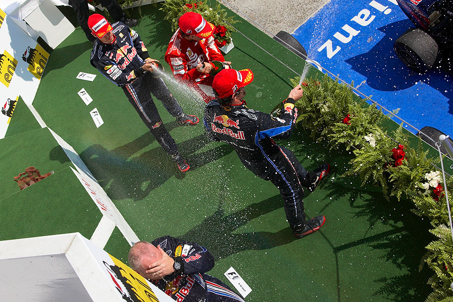 Red Bull's race winner Mark Webber sprays champagne from the Hungarian GP's podium