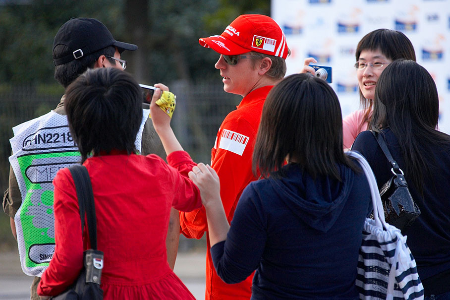 Chinese fans run after reigning World Champion Kimi Raikkonen