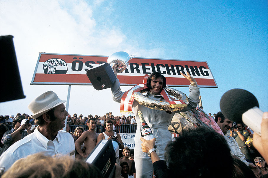 Emerson Fittipaldi celebrates his win on the podium after the Austrian GP 1972