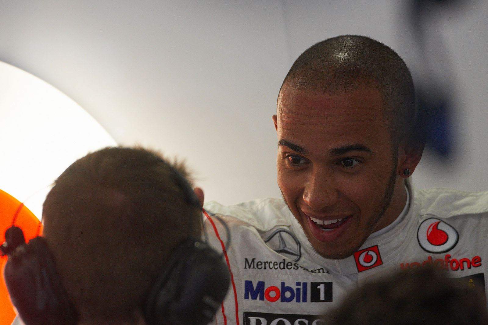 Lewis Hamilton discusses with an engineer in McLaren pits