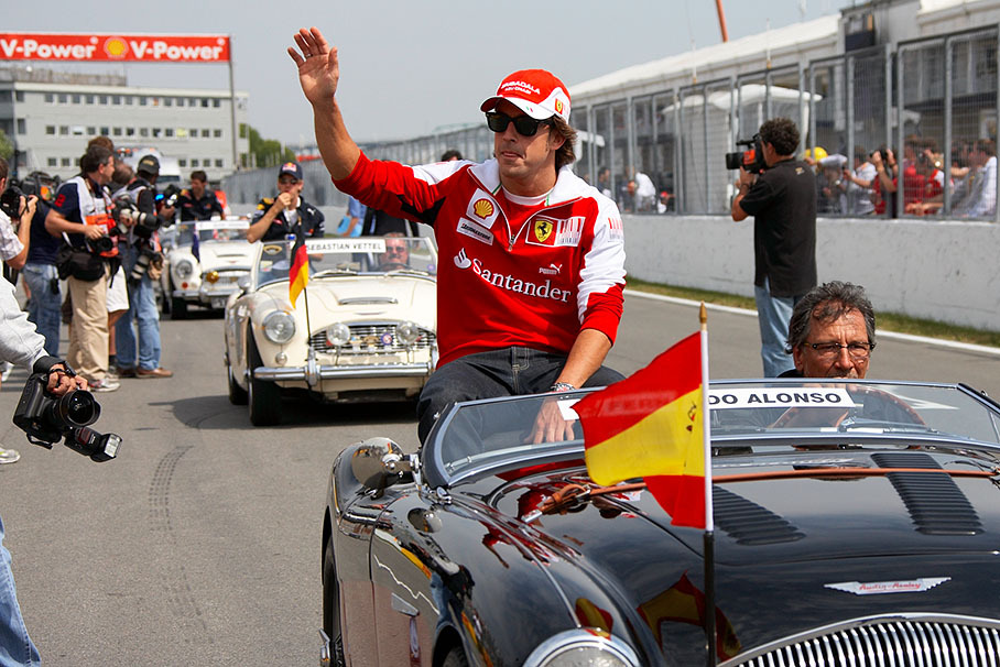 Fernando Alonso waves at the fans