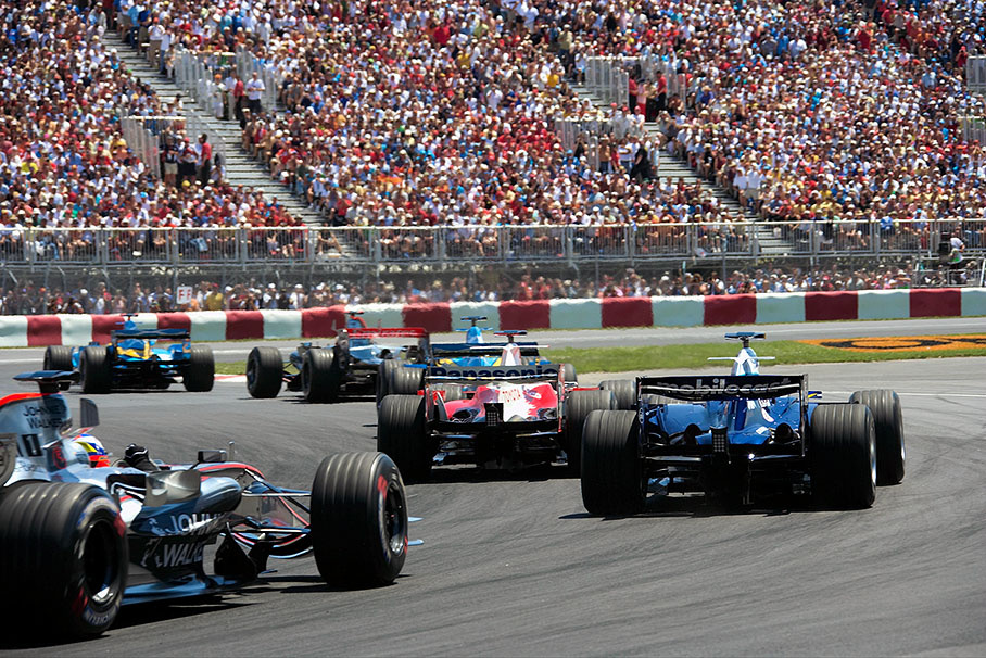 Fernando Alonso leading Raikkonen and Fisichella through first chicane after start
