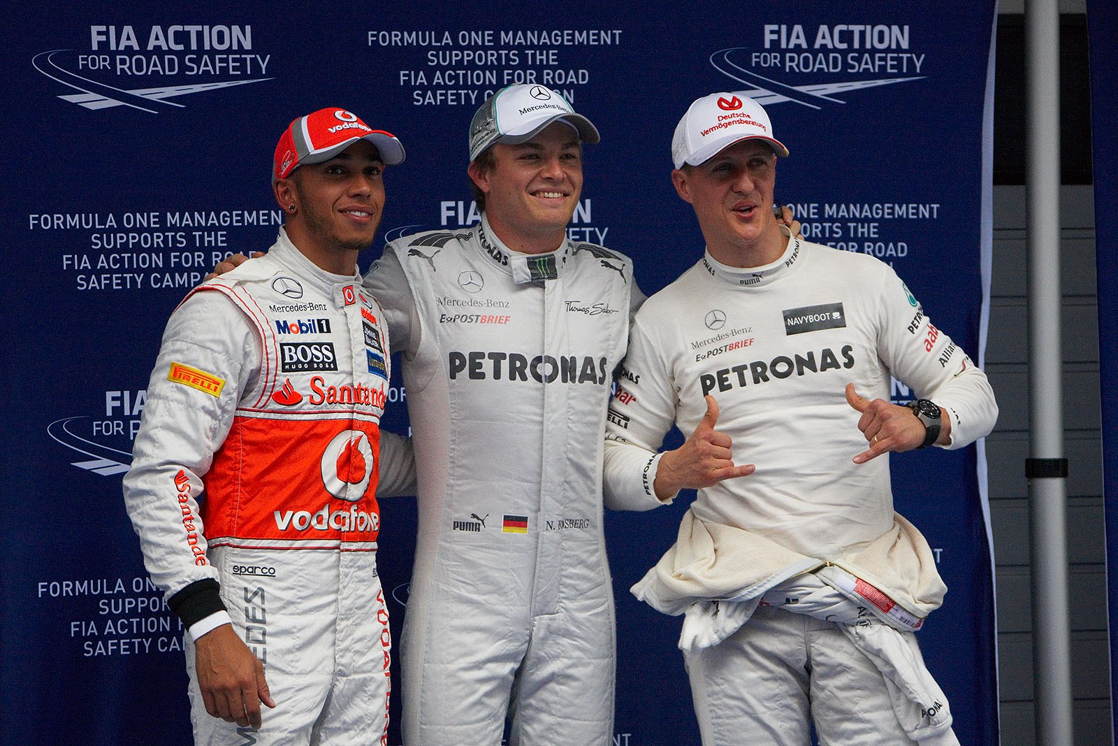 The fastest three qualifiers pose for the world's media: on the left hand second qualified Hamilton (who will have to move five places backwards on the grid due to an unplanned gearbox change, Kobayashi will move to third grid position), Nico Rosberg of Mercedes as polesetter in the middle and his team mate Michael Schumacher as third placed (now second on the grid).