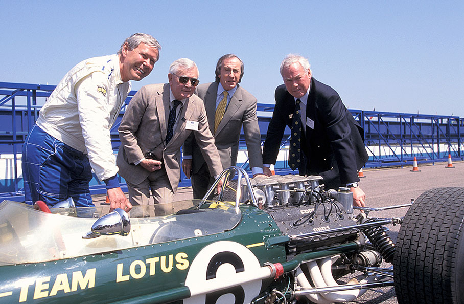 Annyversary celebration of 30 years of Cosworth engines being entered in Formula 1 at Donington: groupshot of Dick Scammel, Walter Hayes, Jackie Stewart and Keith Duckworth together with the Lotus-Cosworth of the first days