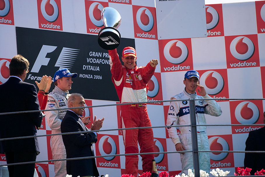 Victorious Michael Schumacher raising his trophy on podium