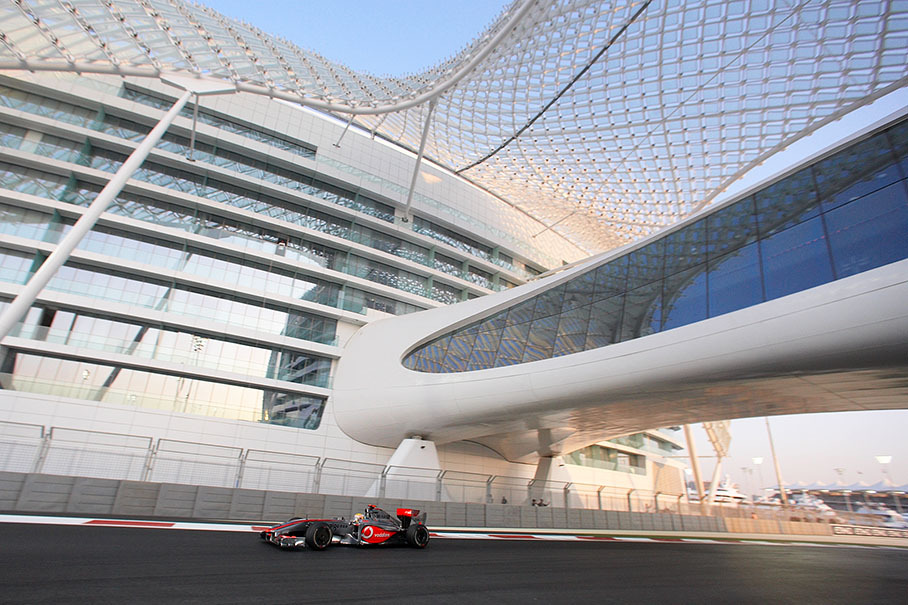 Lewis Hamilton, McLaren Mercedes, passes the Yas Marina Hotel complex