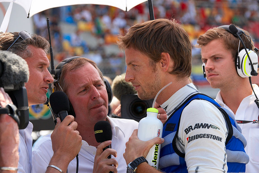 Brawn GP's Jenson Button is being interviewed on the grid by BBC TV presenters and former colleagues in F1 David Coulthard and Martin Brundle
