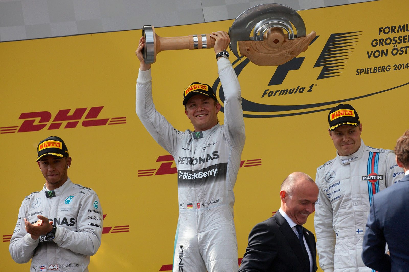 Winner Mercedes' German driver Nico Rosberg holds his trophy as he celebrates on the podium after the Austrian Grand Prix at Spielberg, 2014