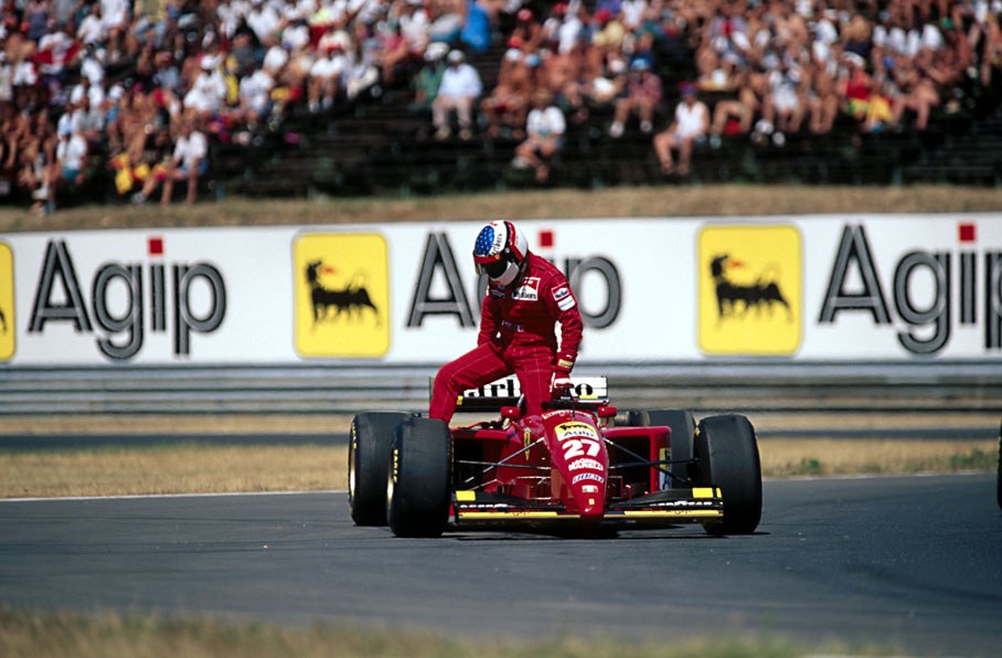Jean Alesi jumps out of his retired car