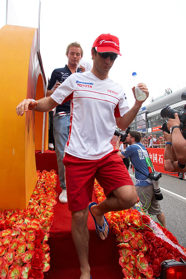 Jarno Trulli comes down from the drivers parade truck