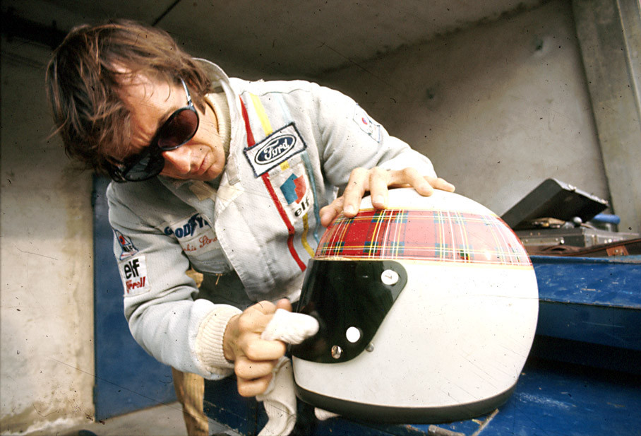 Jackie Stewart cleans his helmet