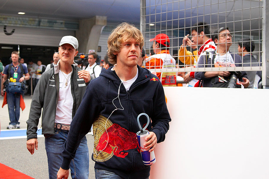 Sebastian Vettel walks to drivers parade, followed by Michael Schumacher