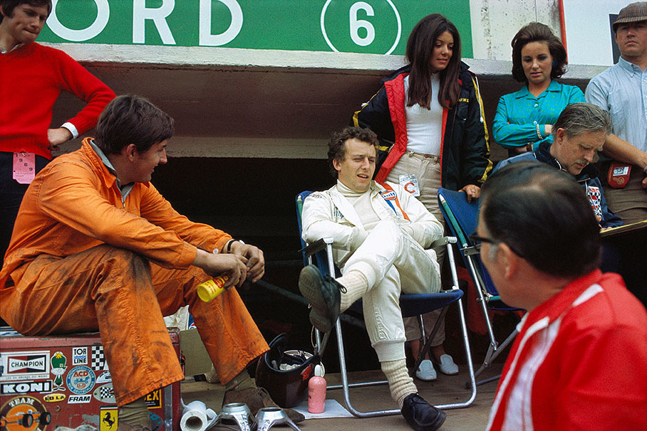Ford driver Jackie Oliver and his wife Lynn (black coad) in the pits.