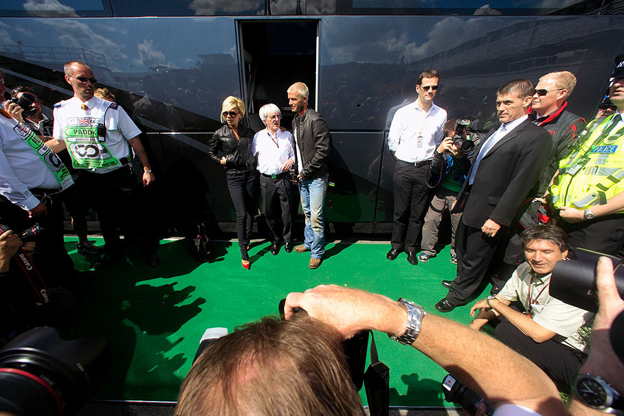 Bernie Ecclestone with VIP guests Victoria and David Beckham in front of his mobile office