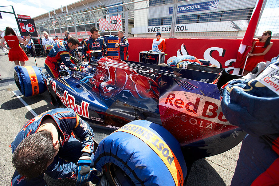 Sebastien Buemi surrounded by Toro Rosso mechanics on his grid position