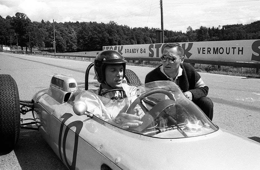 Dan Gurney sits in the cockpit of the Porsche 804, besides him an american journalist