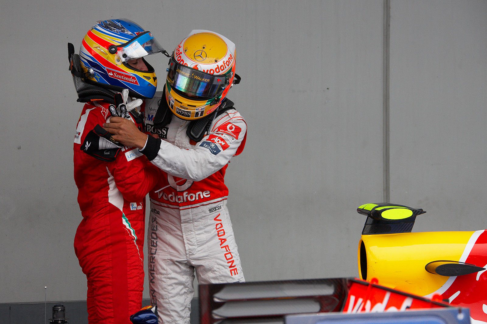 Second placed Fernando Alonso of Ferrari congratulates race winner Lewis Hamilton of McLaren