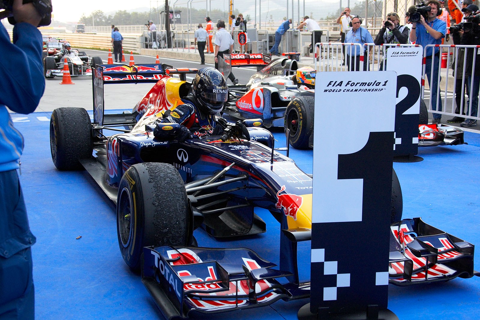 Sebastian Vettel, Red Bull Racing, climbs out of his car in parc ferme after winning the Korean GP