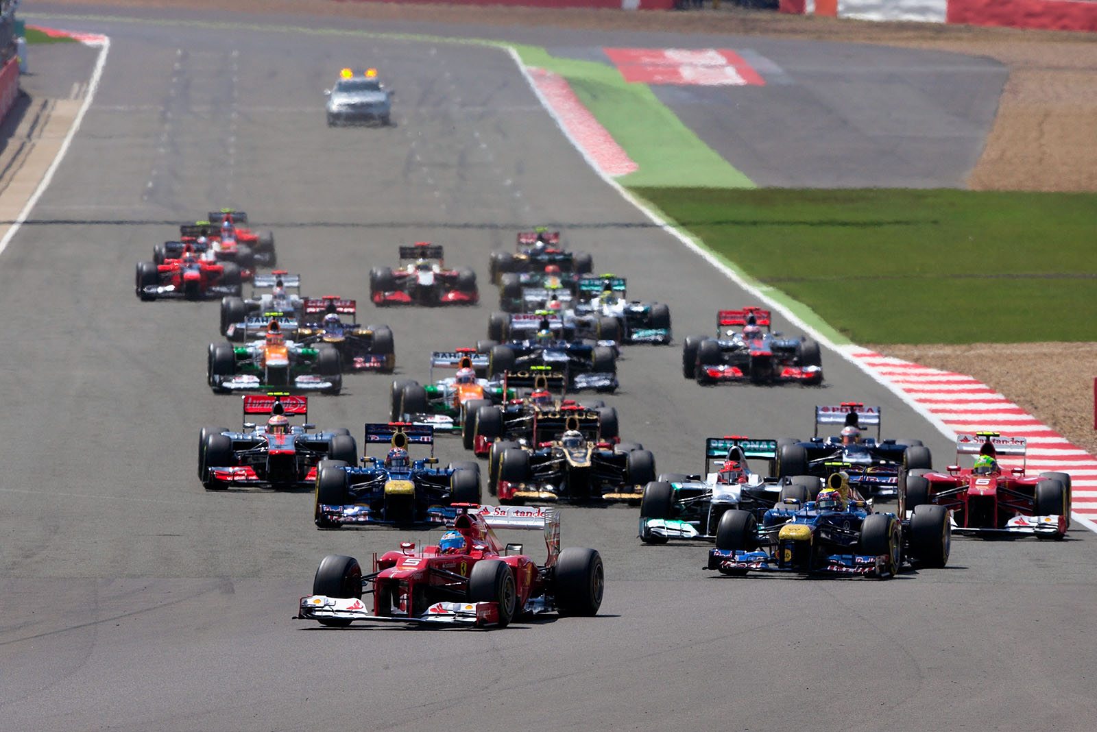 At the start, Alonso's Ferrari is in the lead with Webber behind him