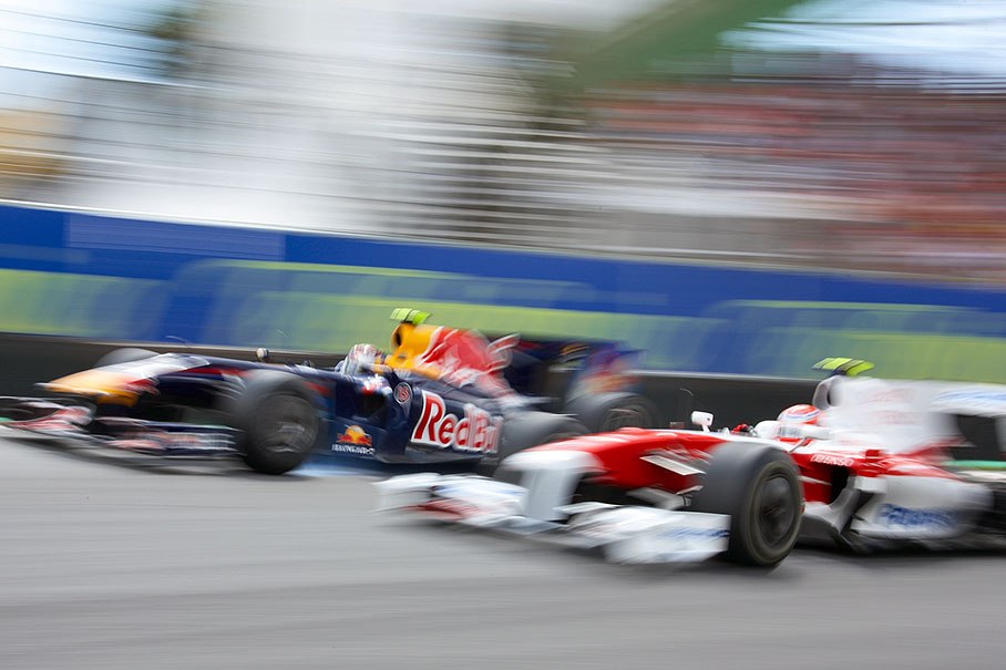 Sebastian Vettel of Red Bull Racing and Toyota's Kamui Kobayashi wheel-to-wheel