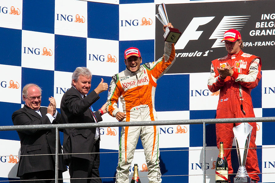 The delighted second placed Giancarlo Fisichella shakes his trophy