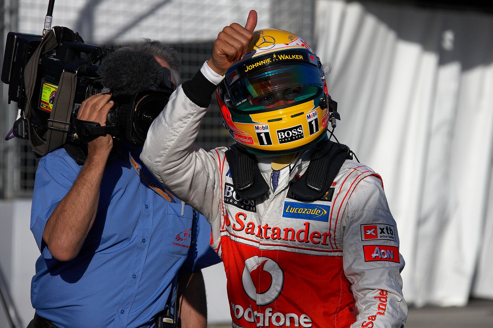 Polesitter Lewis Hamilton of McLaren gives a thumbs-up after qualifying