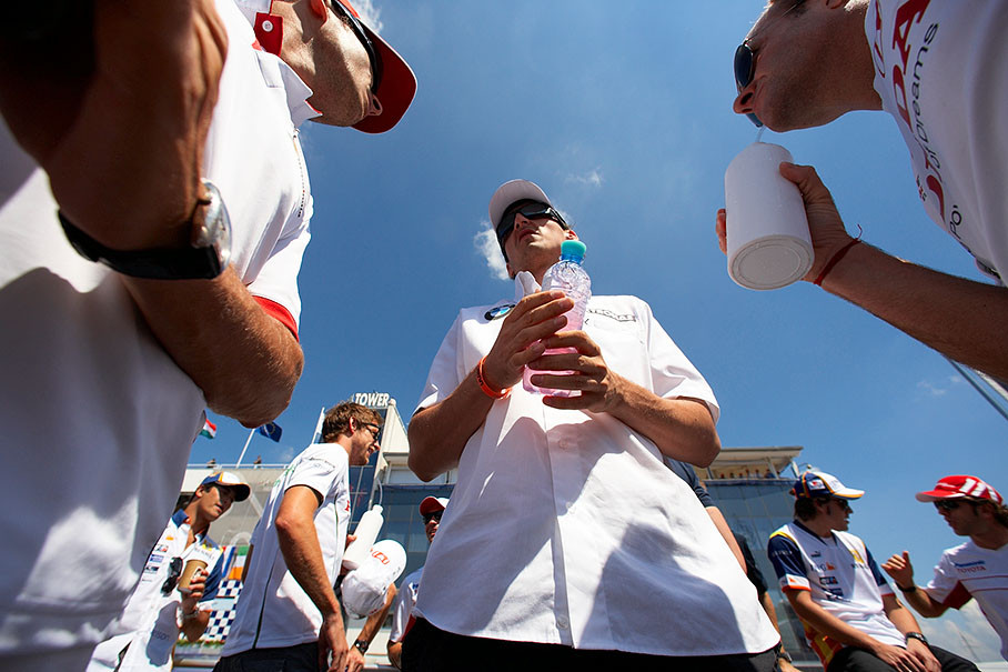 A frog's view at Robert Kubica who talks with Fisichella (left) and Barrichello (right hand), in the back Piquet jr., Button, Alonso and Trulli