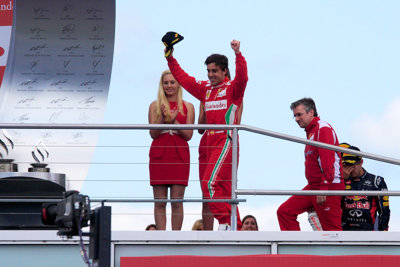 Race winner Fernando Alonso celebrates on the podium after the German Grand Prix