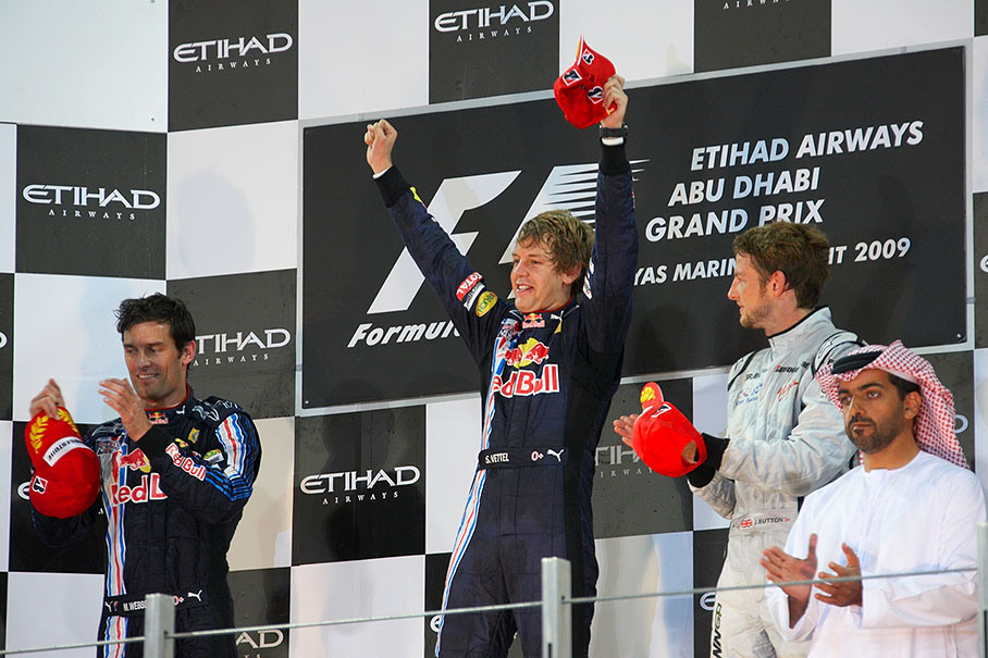 Race winner Sebastian Vettel celebrates on Abu Dhabi's podium