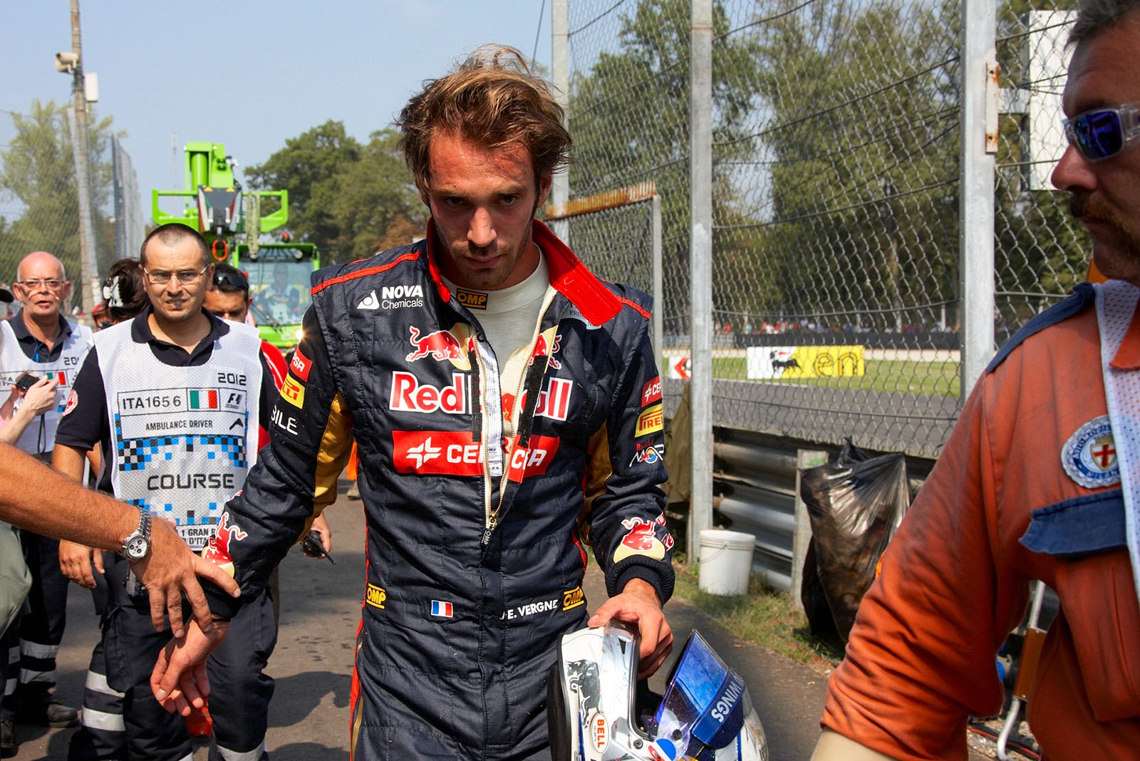 Jean-Eric Vergne of Toro Rosso walks after he got airborne on first turn after a few laps of the race