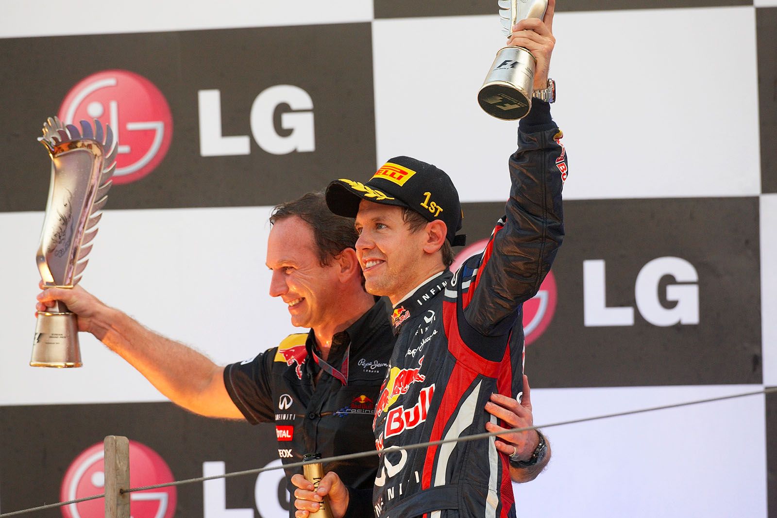 Final podium ceremony photo of race winner Sebastian Vettel and Red Bull Racing team boss Christian Horner as winning constructor of the championship