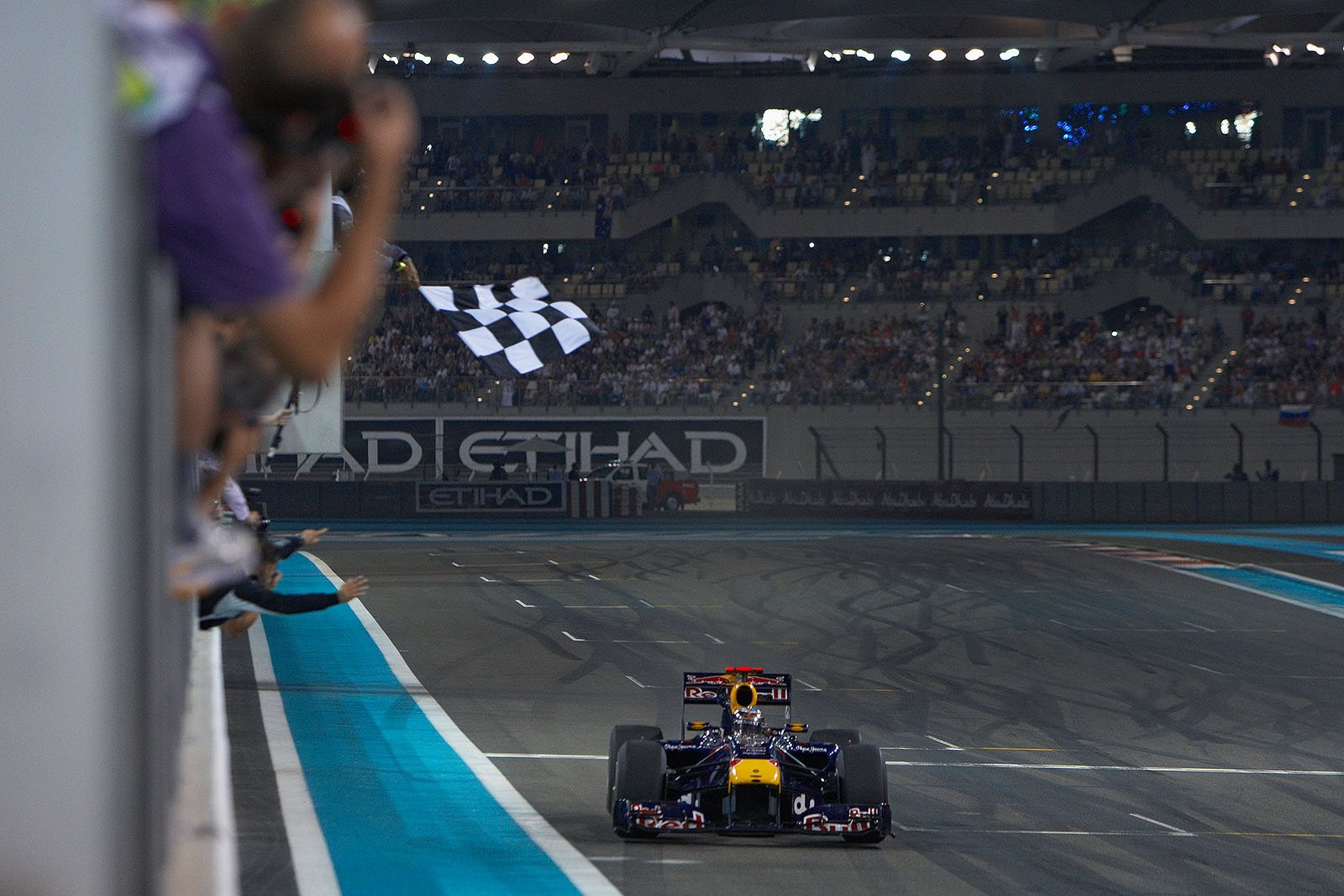 Sebastian Vettel, Red Bull Racing, takes the chequered flag and becomes the youngest F1 World Champion ever