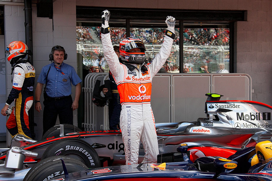 Polesitter Heikki Kovalainen cheers up to his supporting fans
